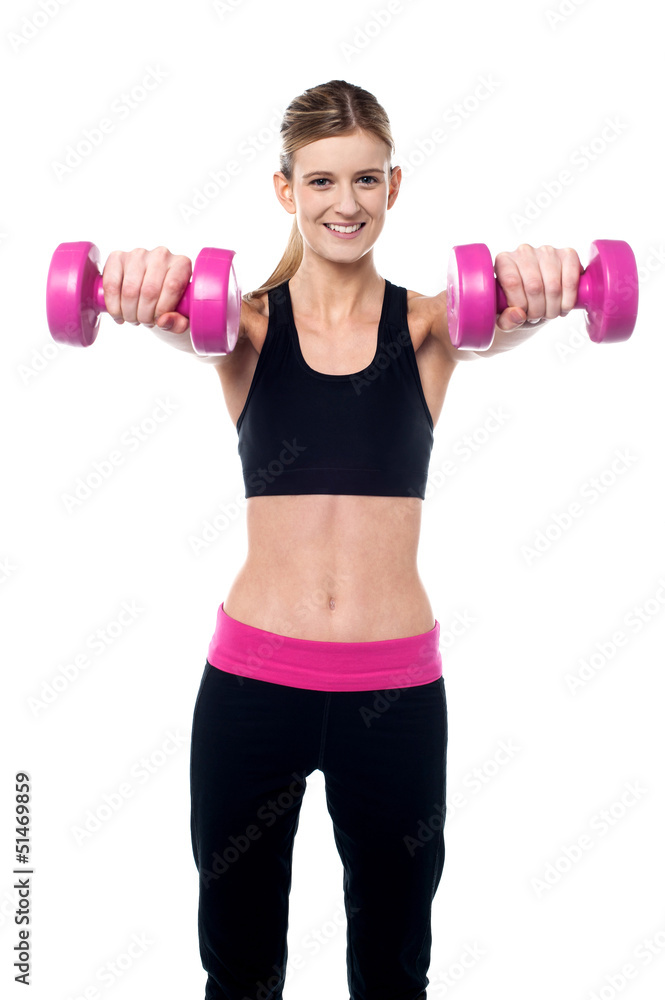 Trainer holding dumbbells in her outstretched arms Trainer holding dumbbells in her outstretched arms