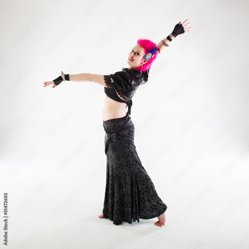 Pink haired belly dancer on white background in a studio shot. Pink haired belly dancer on white background in a studio shot.