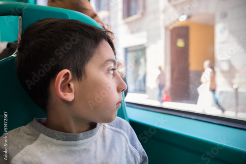 Little boy sit in bus chair going to school