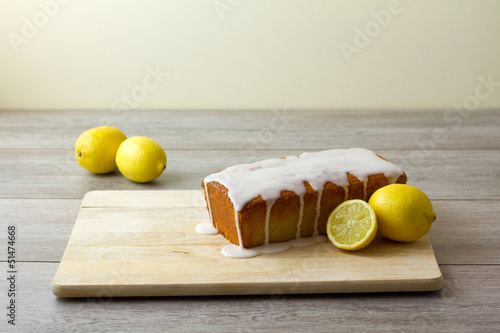 A glazed and unsliced lemon loaf cake