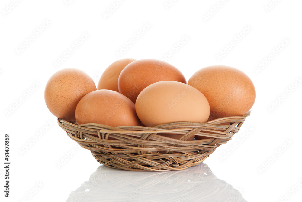 Brown eggs in the basket on white. Brown eggs in the basket on white.