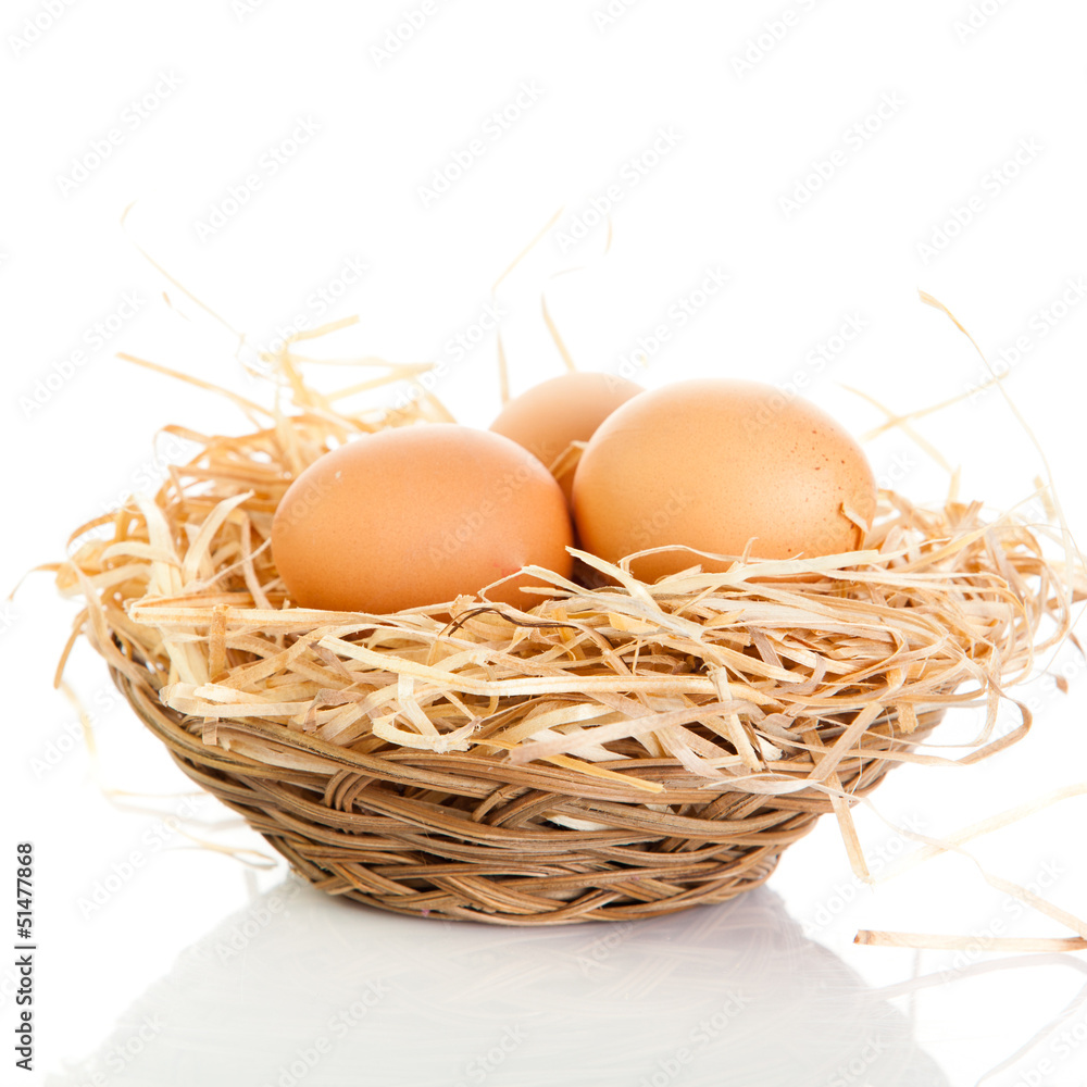 Brown eggs in the basket on white. Brown eggs in the basket on white.