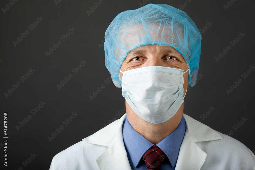 Male physician in mask and cap