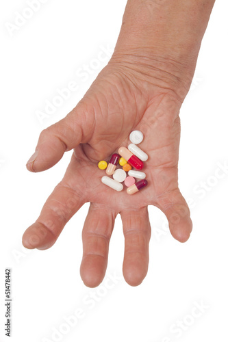 Old Woman's Hand Deformed From Rheumatoid Arthritis holding pill
