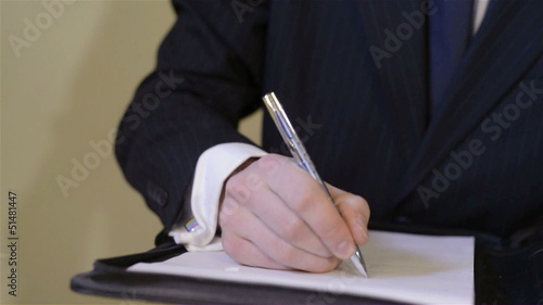 Businessman writing and signing a contract