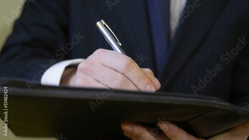 Businessman writing and signing a contract
