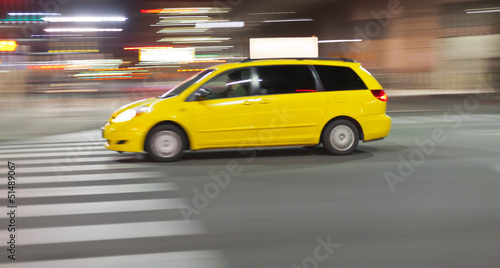 Speeding Taxi cab at night in city