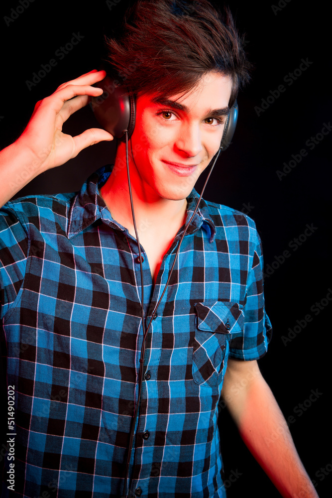 Young and handsome dj with headphones - Disco light effect Young and handsome dj with headphones - Disco light effect