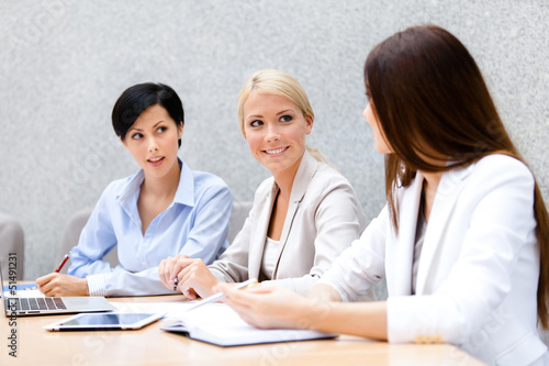 Female colleagues discuss business plan