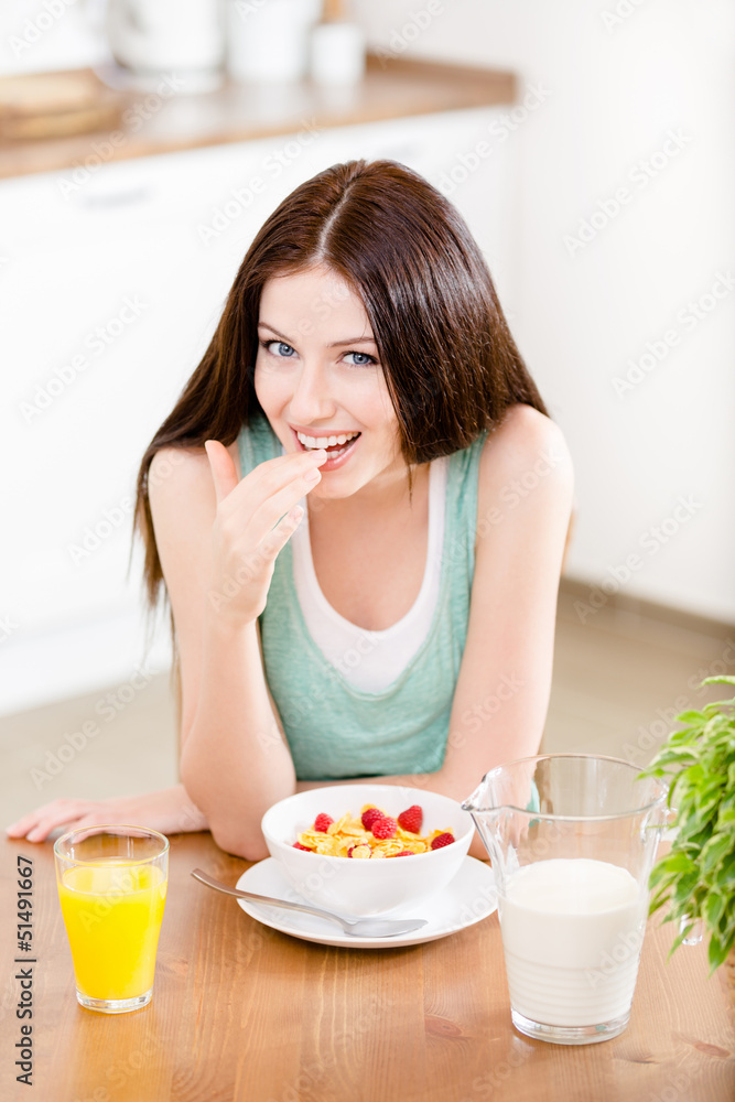 Portrait of the girl eating healthy cereals with milk