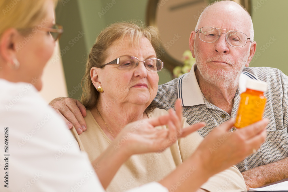Doctor or Nurse Explaining Prescription Medicine to Senior Coupl Doctor or Nurse Explaining Prescription Medicine to Senior Coupl