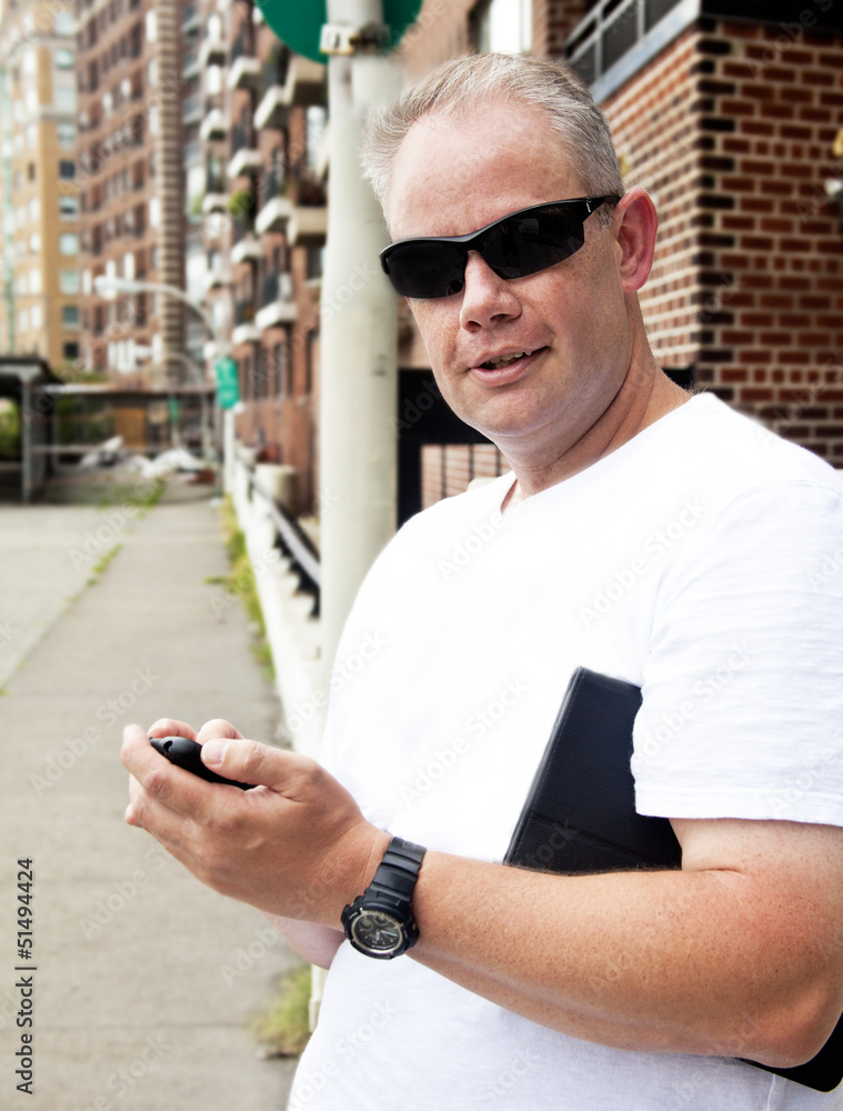 Man on city street with cell phone Man on city street with cell phone