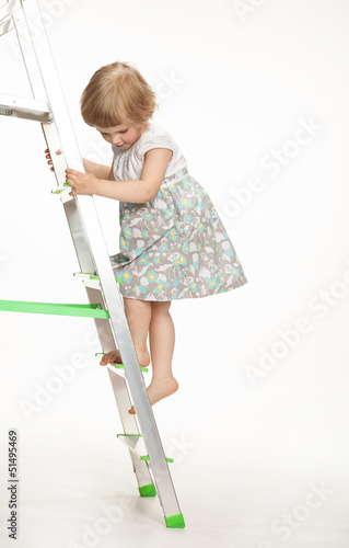The naughty little girl walking down the stepladder