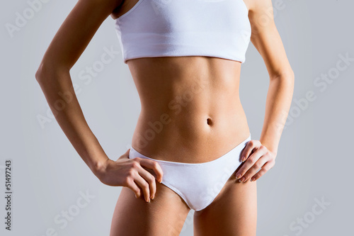 Fototapeta Naklejka Na Ścianę i Meble -  Slim tanned woman's body