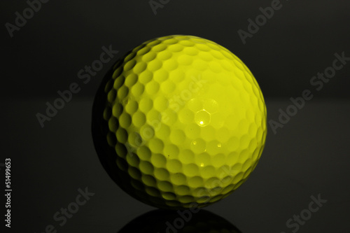 Golf ball on grey background