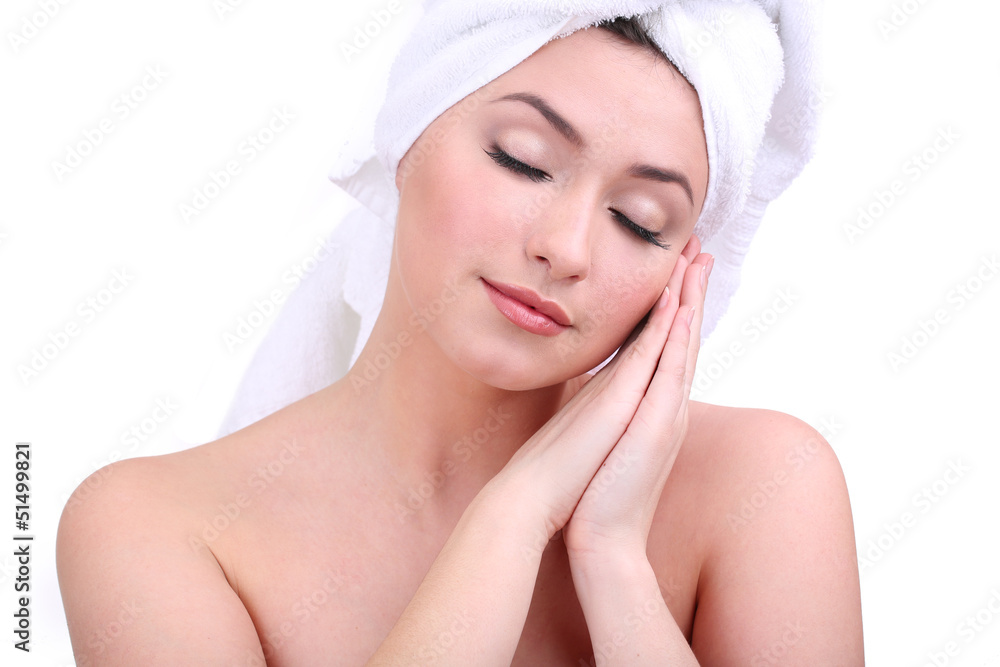 Beautiful young woman with towel on her head isolated on white Beautiful young woman with towel on her head isolated on white