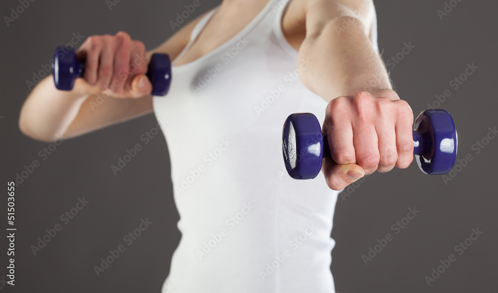 Woman doing fitness exercises with dumbbells Woman doing fitness exercises with dumbbells