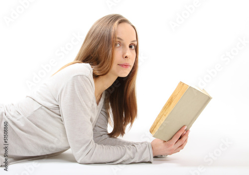 Lying girl with a book on white background © Vasily Merkushev
