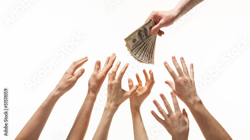 Many hands reaching out for money
