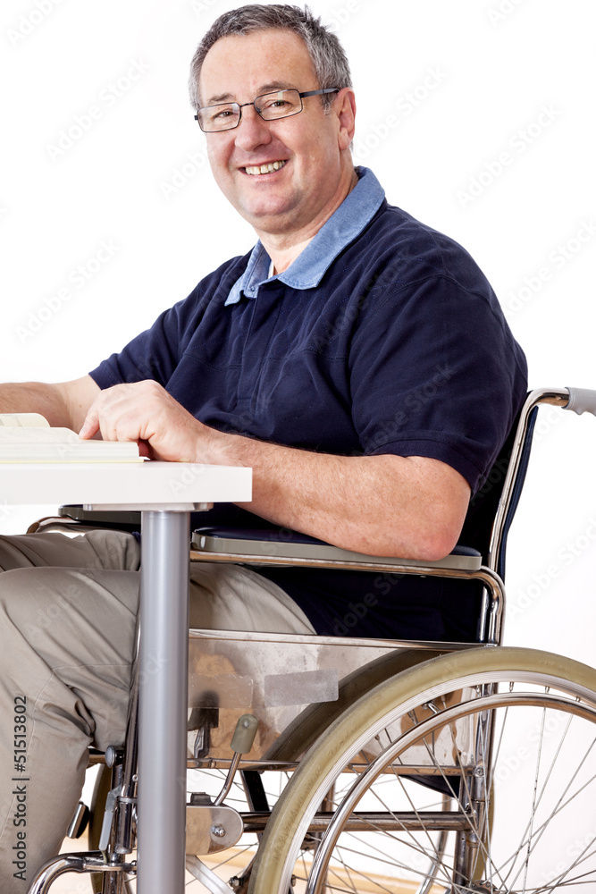 Man sitting in a wheelchair at the table Man sitting in a wheelchair at the table