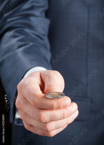 Businesman tossing a coin