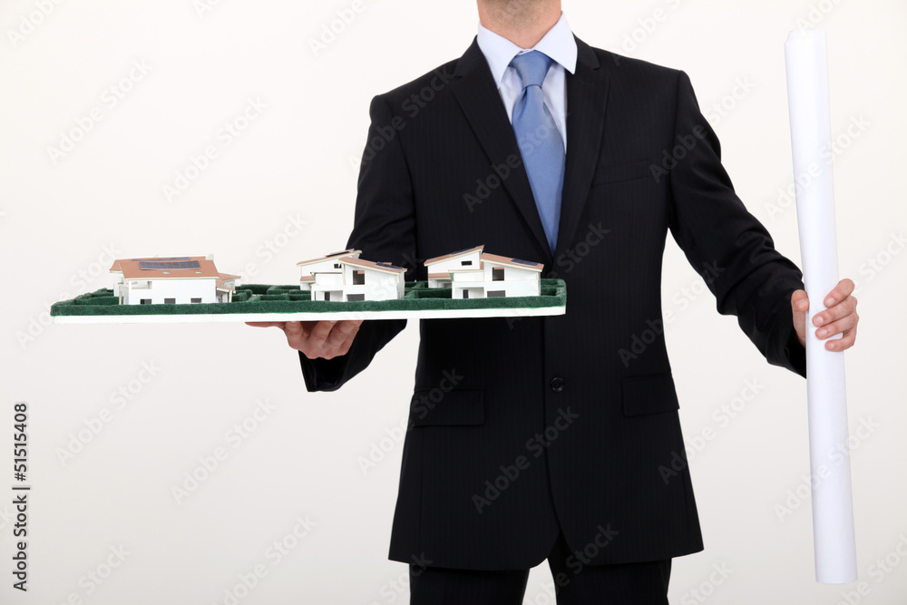 businessman holding an architectural model businessman holding an architectural model