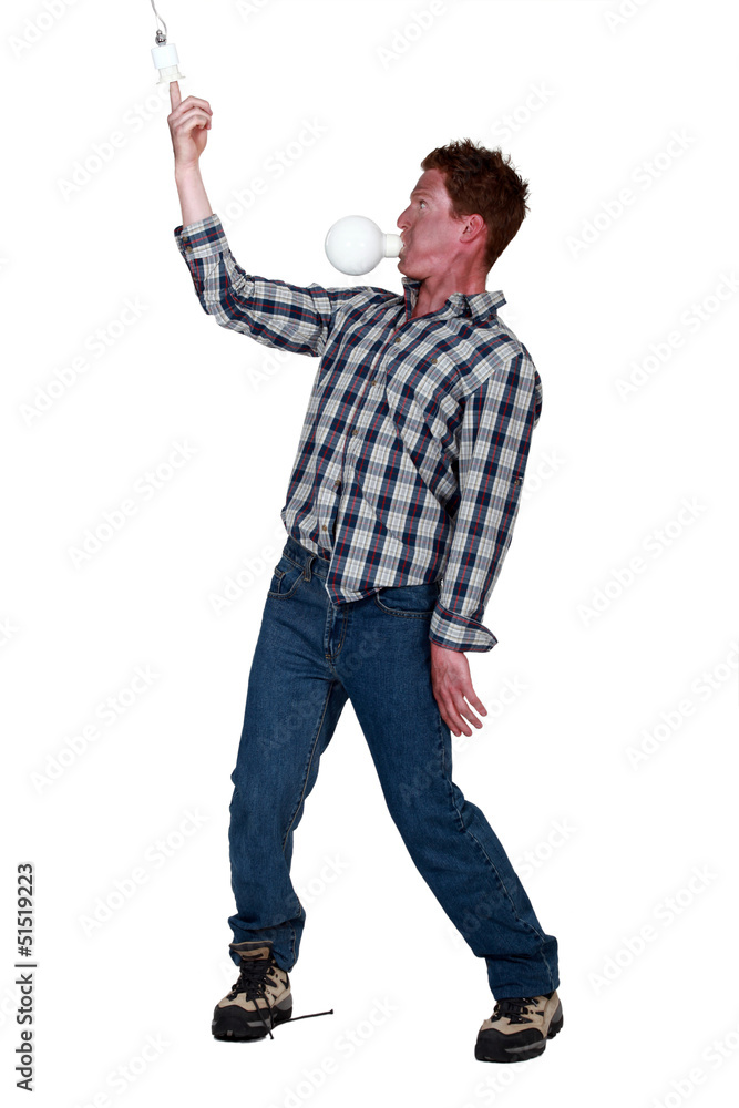 Man with light bulb in the mouth Man with light bulb in the mouth