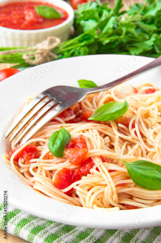 Traditional Italian tasty meal pasta with tomato sauce and basil