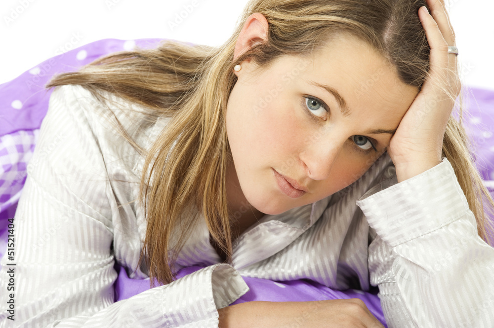 Fototapeta premium Young woman lying in bed