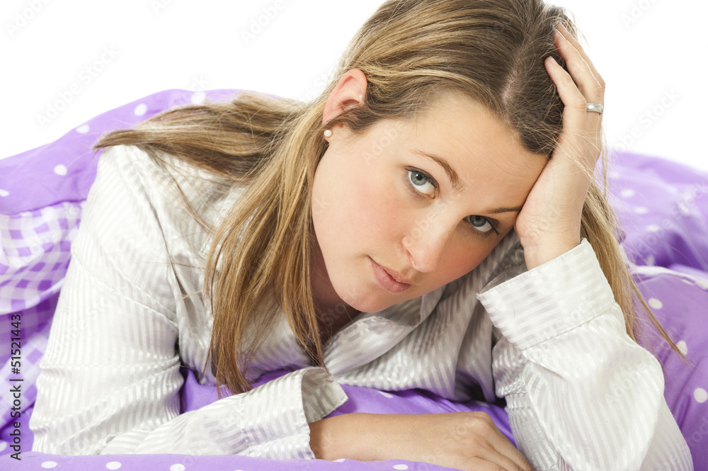 Fototapeta premium Young woman lying in bed