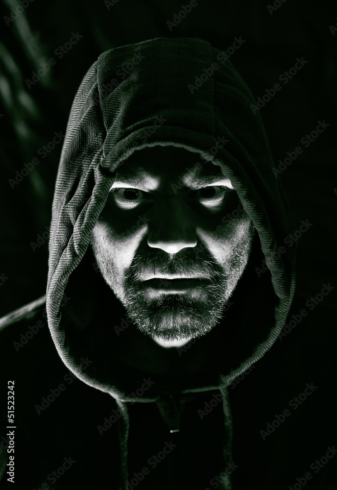 Scary evil man with hood in darkness Scary evil man with hood in darkness
