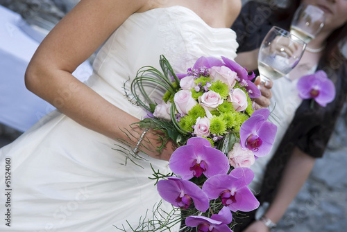 Bride holding whine glass and beautiful bridal bouquet