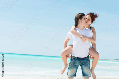 Portrait of a happy young couple having fun on the beach
