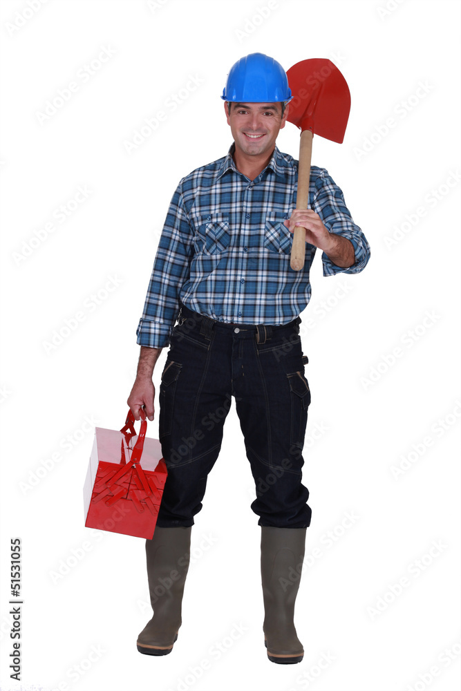Tradesman carrying a spade and a toolbox Tradesman carrying a spade and a toolbox