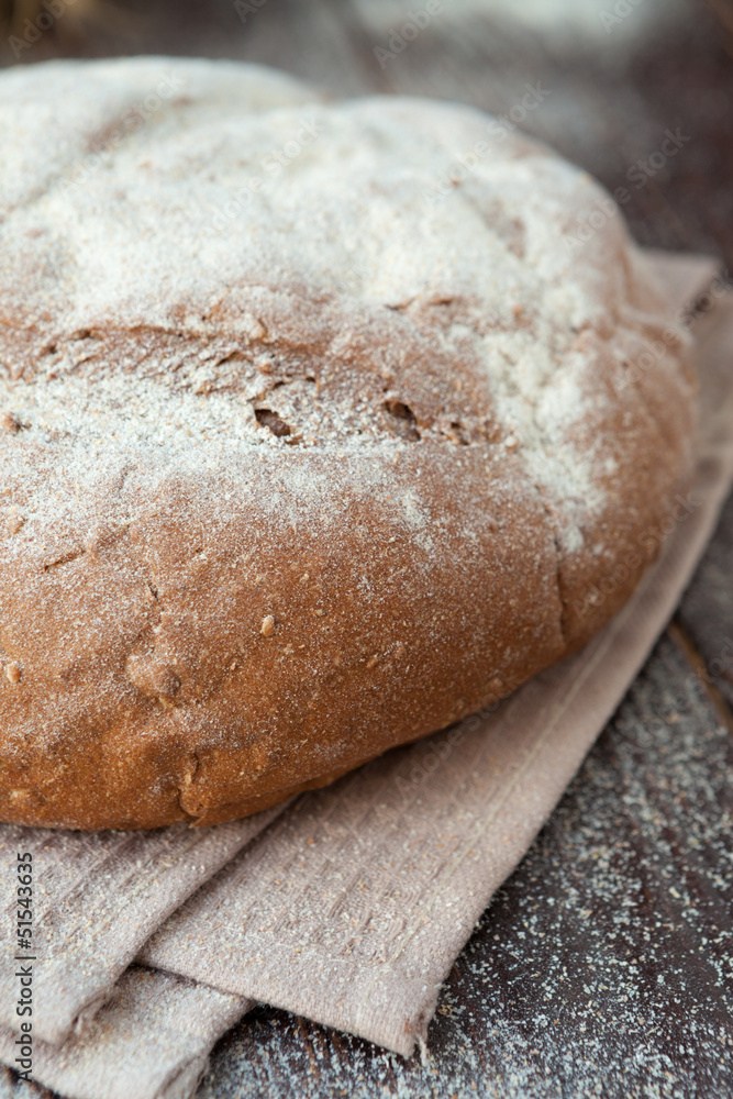 round loaf of bread on the boards