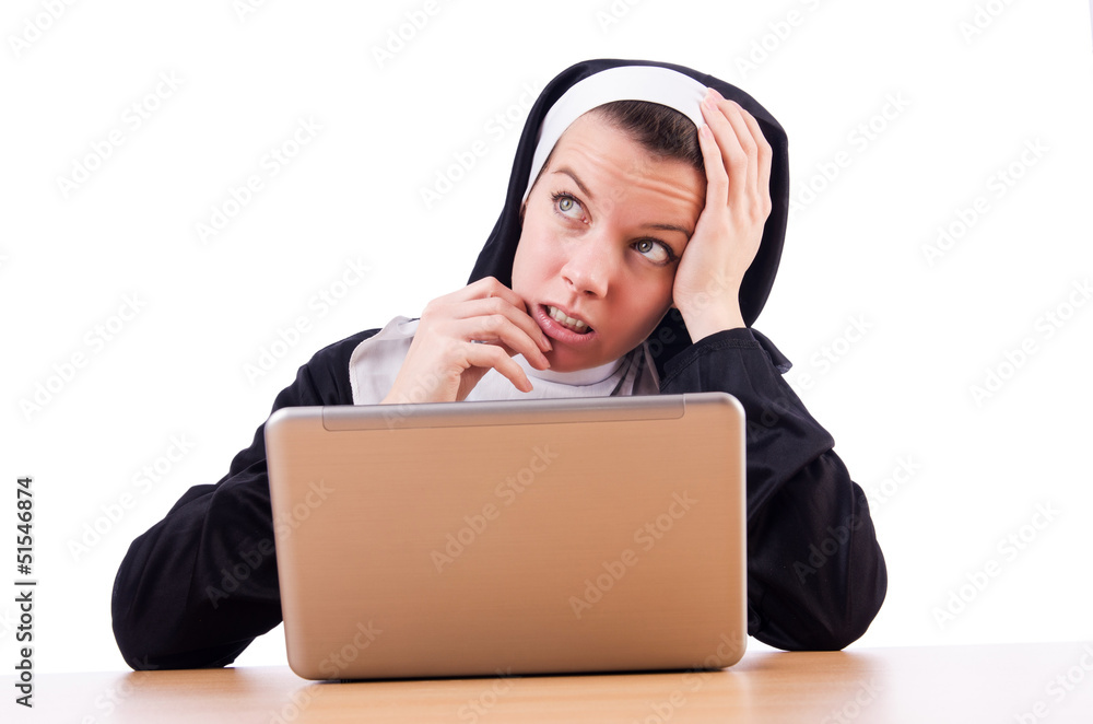 Nun working on laptop - religious concept Nun working on laptop - religious concept