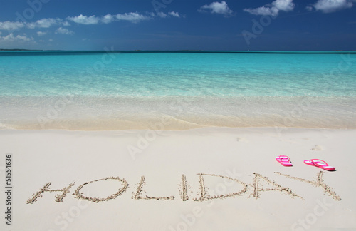 HOLIDAY writing on the sandy beach of Exuma  Bahamas