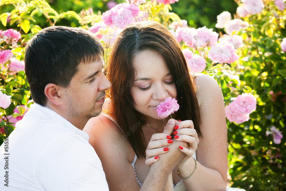 Obraz premium Two lovers in rose garden