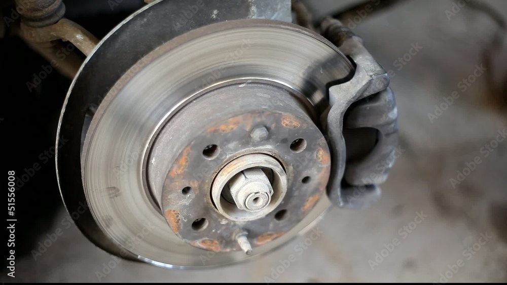 Closeup photo of car disc brakes servicing Closeup photo of car disc brakes servicing