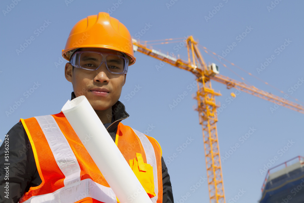 Portraite site manager with safety vest under construction Portraite site manager with safety vest under construction
