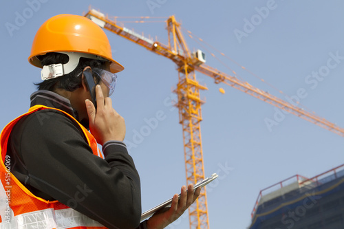 construction worker with crane in background