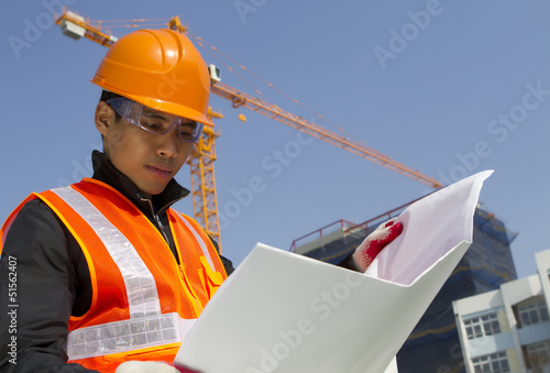 construction worker with crane in background