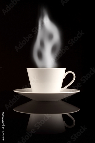 White cup with smoke on black background