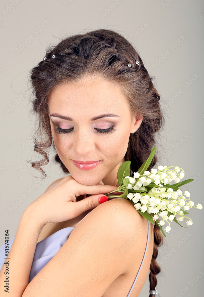 Young woman with beautiful hairstyle and flowers,