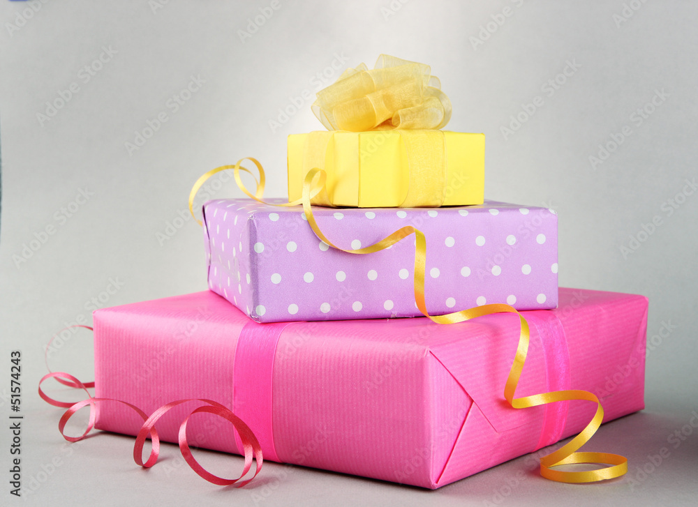 Bright gifts with bows on grey background Bright gifts with bows on grey background