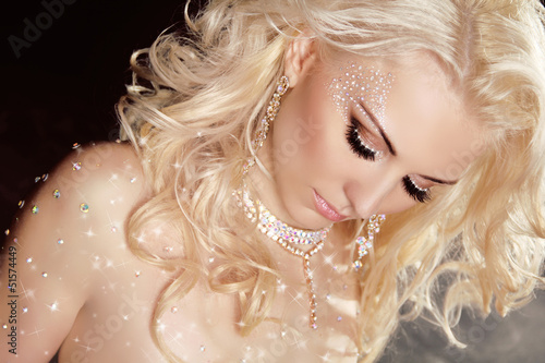 Closeup of blond sexy girl model wearing in twinkled crystals wi