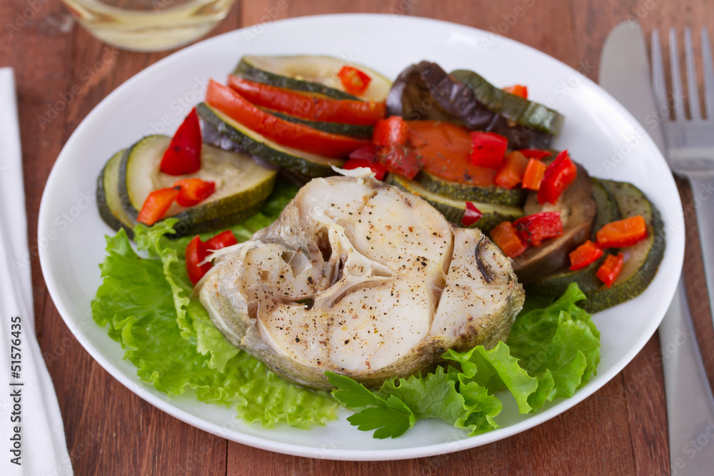 fish with salad and vegetables on the plate fish with salad and vegetables on the plate