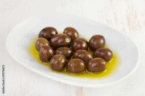 olives with oil on white dish