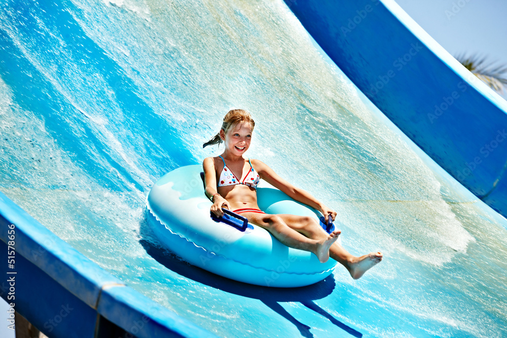 Fototapeta premium Child on water slide at aquapark.
