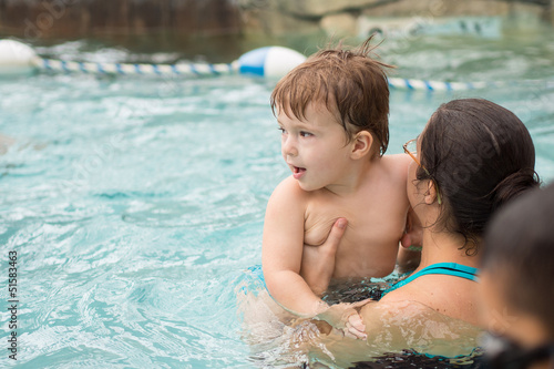 Family playing in the pool